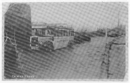 Black & White bus on Worcester Road with Mythe Hill in background.<br>This is the only road that has been completely lifted.