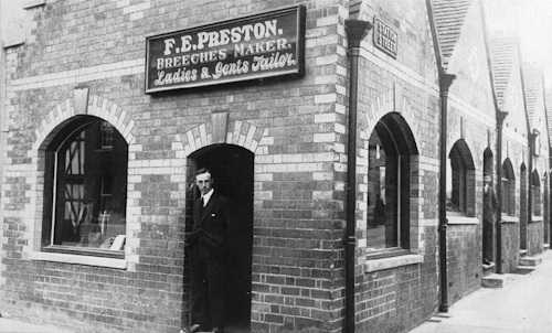 Frederick Preston standing in the doorway of his shop