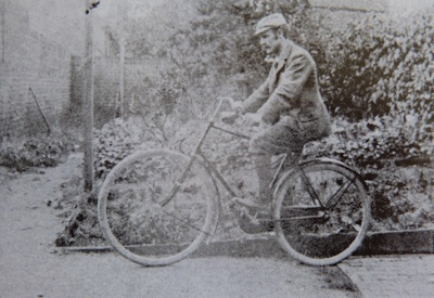 <sub>This Photo of the Pioneer on his bicycle<br>was taken at the rear of 123 High Street, according to<br>Mrs. Gurney.  (Gurney Collection)</sub>